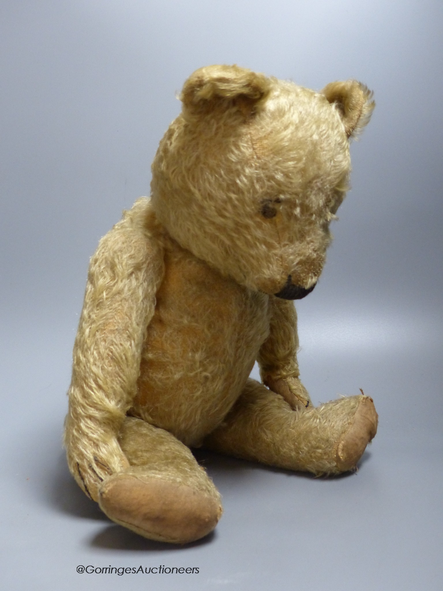 A blonde plush Teddy Bear with a hump back, height 51cm